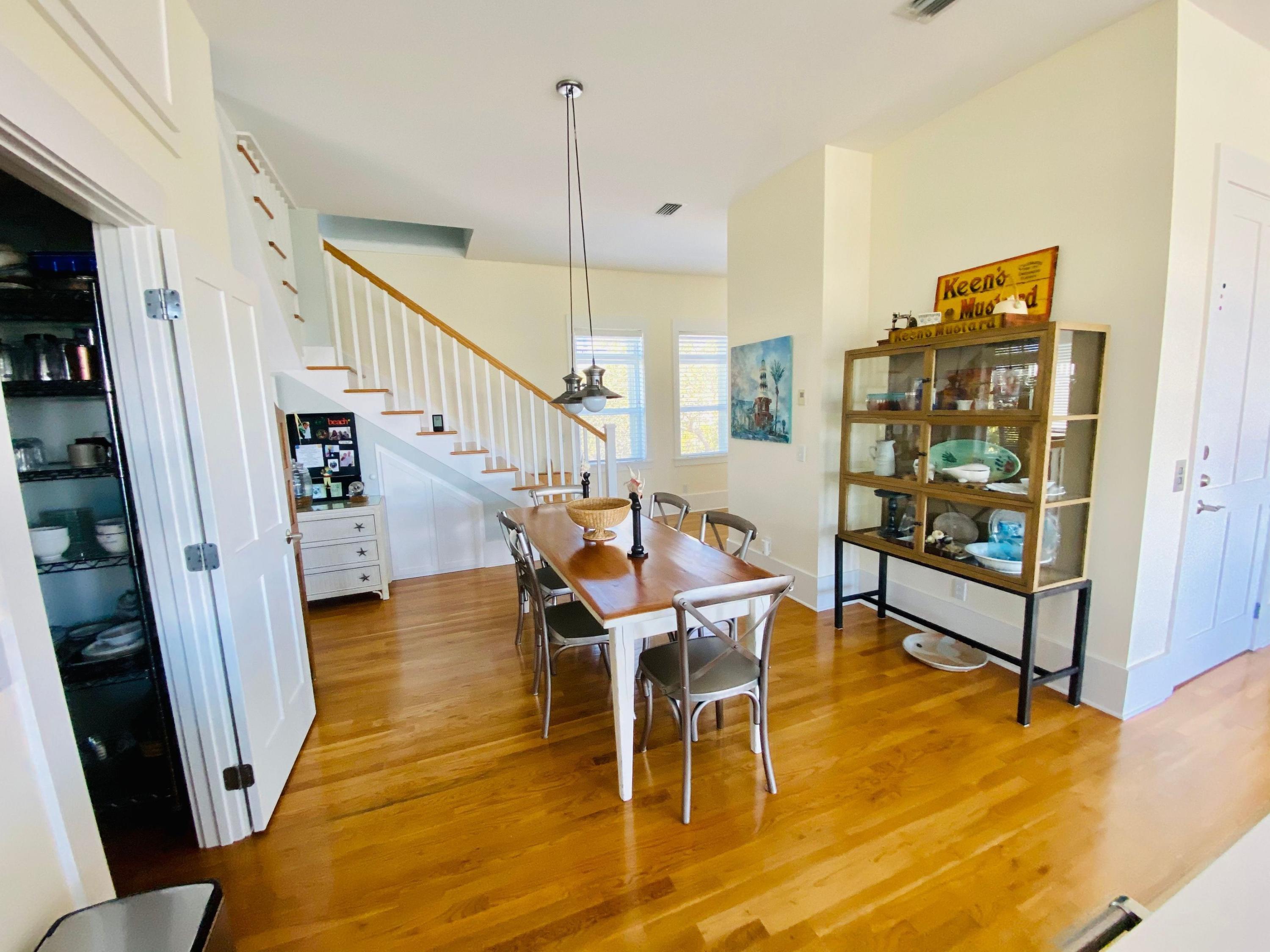 170 Old Beach Road Santa Rosa Beach, FL 32459 - Photo 6 of 35 a dining room with wooden floor and stairs