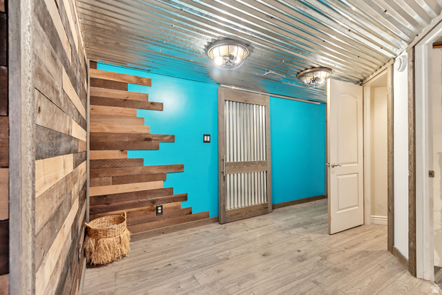 7296 Ridge Road Lake Point, UT 84074 - Photo 31 of 54 Corrugated metal ceiling paired with a vibrant accent wall and wood-finish flooring