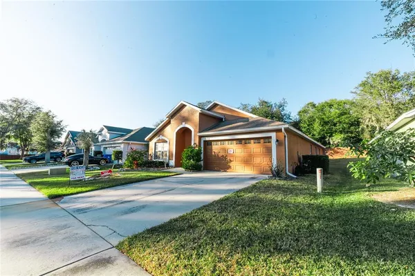 a front view of a house with a yard and garage