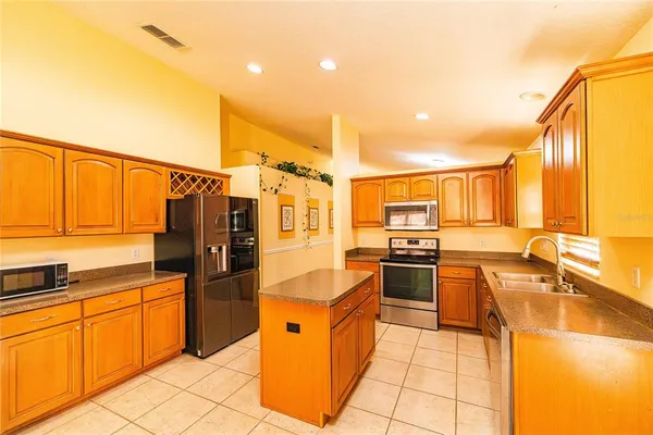 a kitchen with stainless steel appliances granite countertop a sink and cabinets