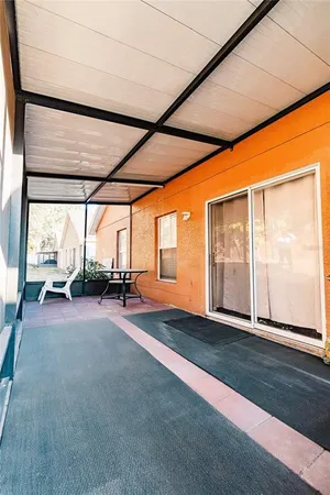 a view of a room with wooden floor and windows