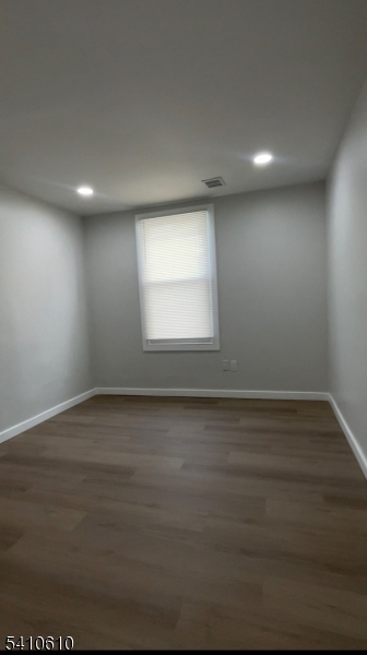 178 3rd Street, Unit 3 Elizabeth Port, NJ 07206 - Photo 2 of 3 an empty room with wooden floor and windows