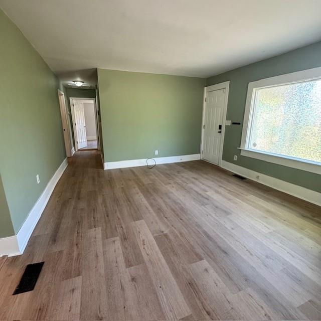2344 Ripplewater Drive Southeast Atlanta, GA 30316 - Photo 4 of 18 an empty room with wooden floor and windows