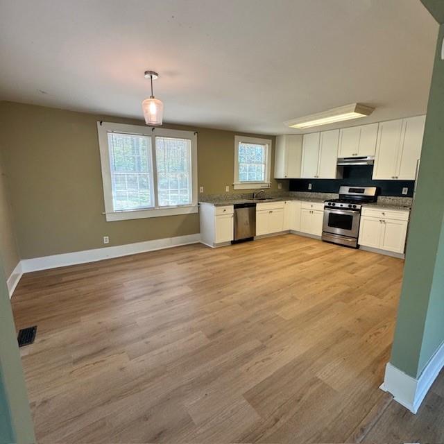 2344 Ripplewater Drive Southeast Atlanta, GA 30316 - Photo 7 of 18 a kitchen with stainless steel appliances granite countertop a stove top oven a sink dishwasher and a microwave oven with cabinets