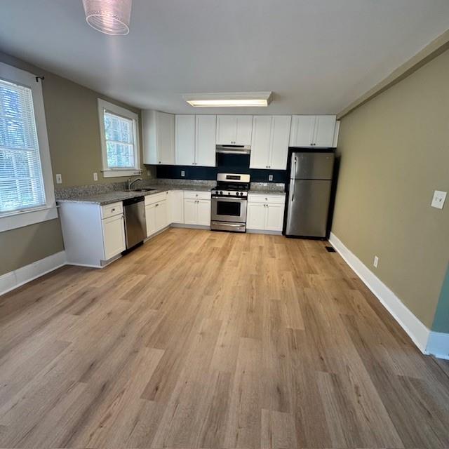 2344 Ripplewater Drive Southeast Atlanta, GA 30316 - Photo 8 of 18 a large kitchen with a large counter top space stainless steel appliances and a window