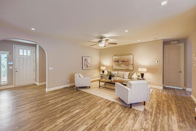 a view of a hallway with wooden floor and a cabinet