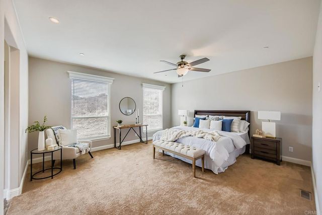 a bedroom with bed and a chandelier