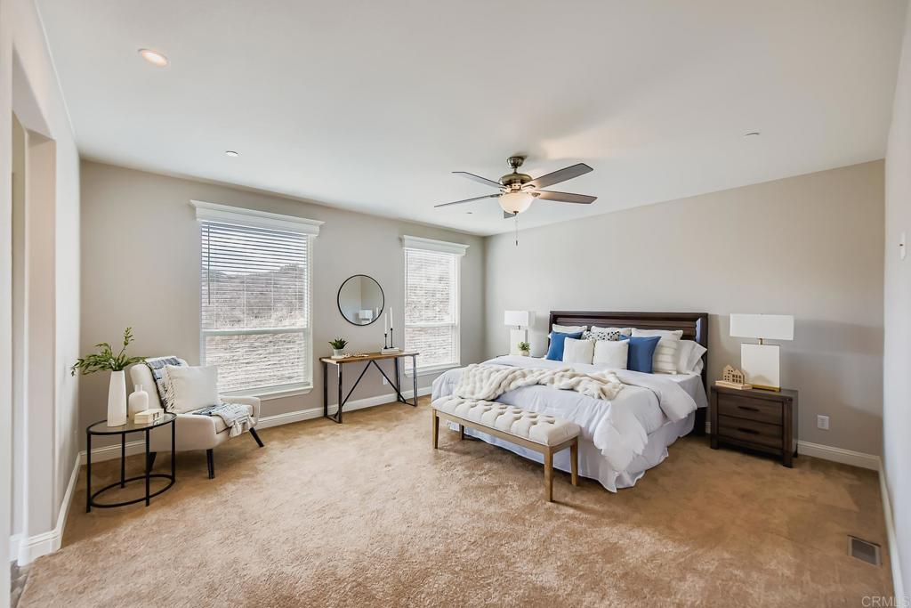 28720 North Twin Oaks Valley Road Vista, CA 92084 - Photo 25 of 66 a bedroom with a bed and a chandelier