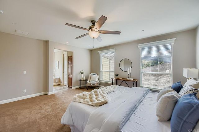 a bedroom with a bed and a night stand