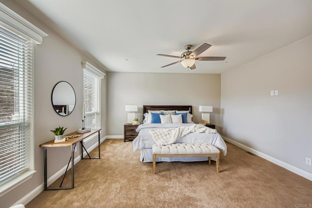 28720 North Twin Oaks Valley Road Vista, CA 92084 - Photo 28 of 66 a bedroom with bed and a chandelier