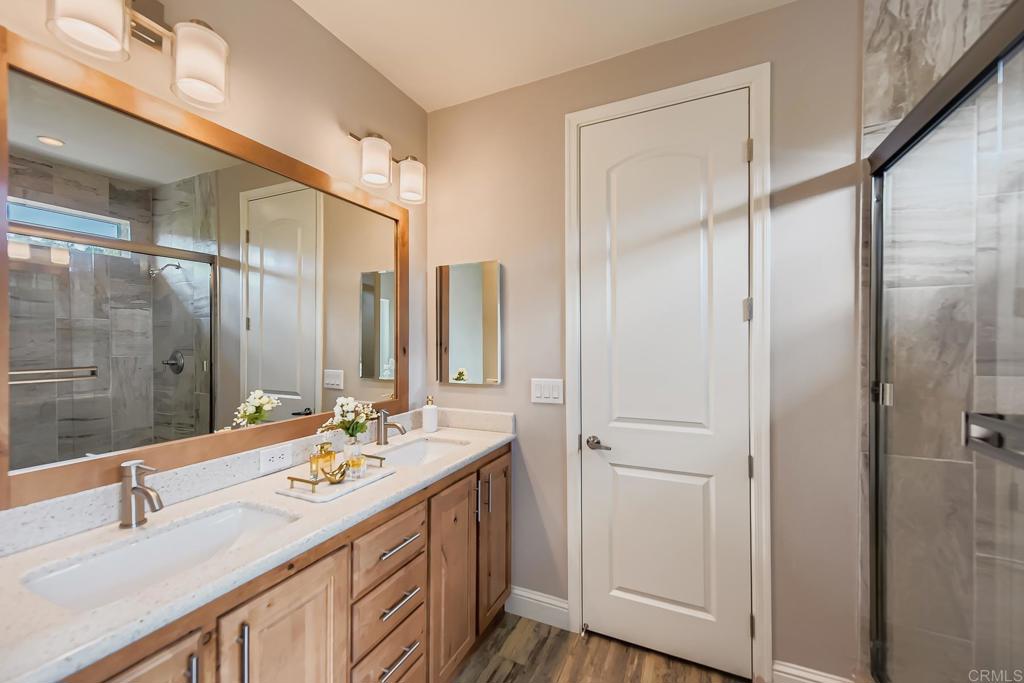 28720 North Twin Oaks Valley Road Vista, CA 92084 - Photo 33 of 66 a bathroom with a double vanity sink and a mirror