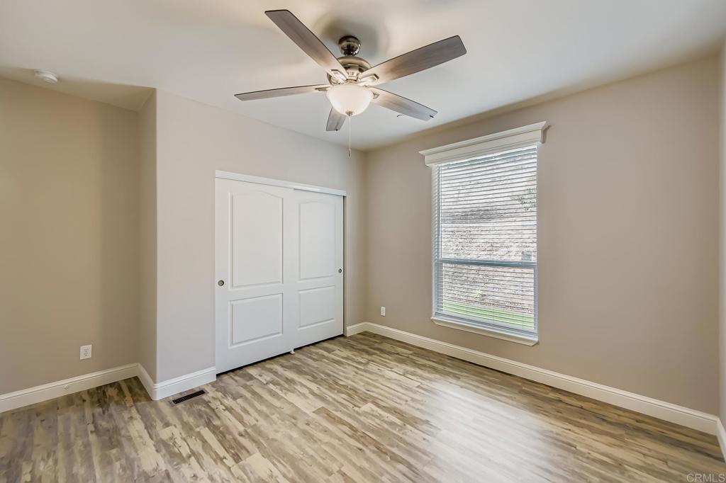 28720 North Twin Oaks Valley Road Vista, CA 92084 - Photo 37 of 66 a view of an empty room with wooden floor and a window