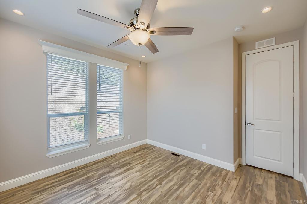 28720 North Twin Oaks Valley Road Vista, CA 92084 - Photo 43 of 66 a view of an empty room with wooden floor and a window