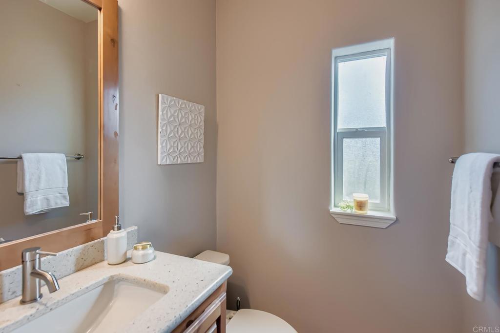 28720 North Twin Oaks Valley Road Vista, CA 92084 - Photo 44 of 66 a bathroom with a sink vanity mirror and toilet