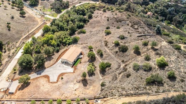 an aerial view of a house with a yard and a garden