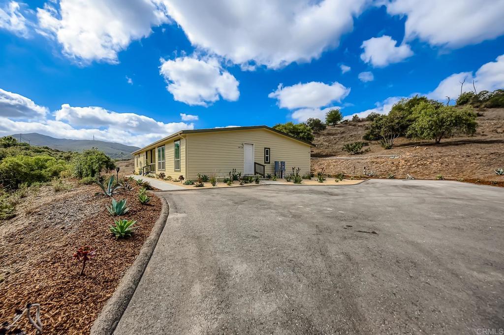 28720 North Twin Oaks Valley Road Vista, CA 92084 - Photo 5 of 66 a view of a house with a yard