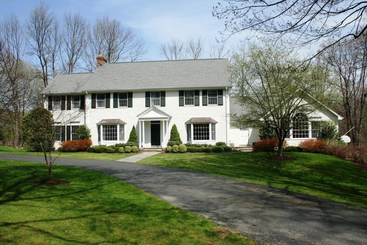 595 Smith Ridge Road New Canaan, CT 06840 - Photo 1 of 25 a front view of a house with a garden