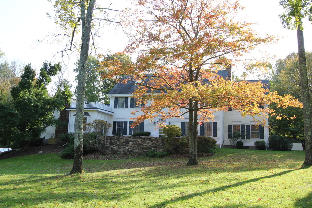 595 Smith Ridge Road New Canaan, CT 06840 - Photo 22 of 25 a front view of a house with a yard