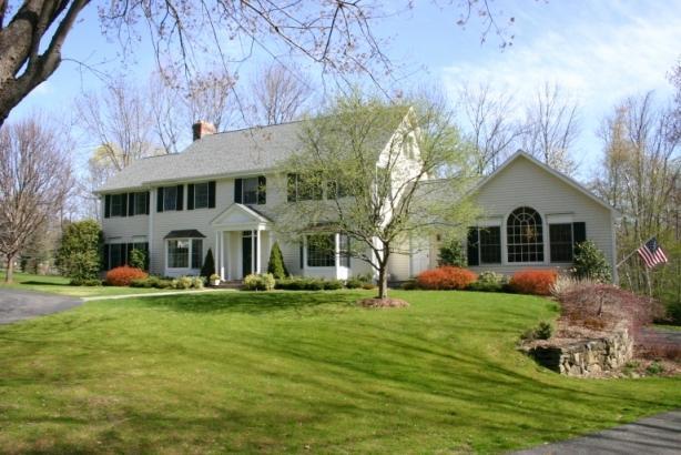 595 Smith Ridge Road New Canaan, CT 06840 - Photo 24 of 25 a front view of house with yard and green space