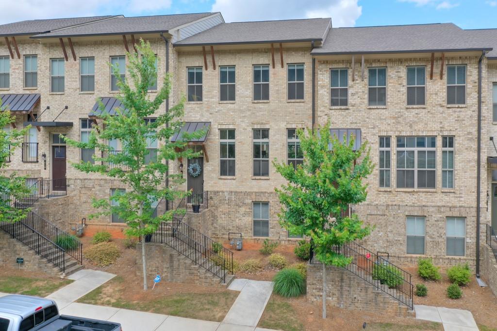 616 Harrington Hills Decatur, GA 30032 - Photo 1 of 1 a front view of a building with a garden and plants