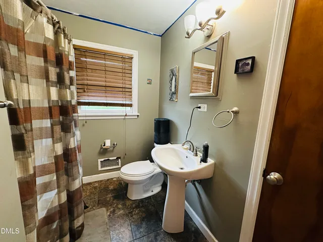 a large kitchen with lots of furniture and stainless steel appliances