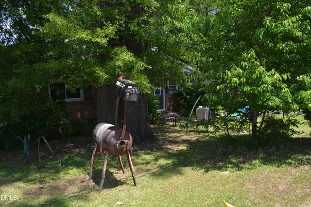 a dining room with a table chairs and a kitchen