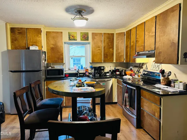 a view of a dining room with furniture and wooden floor