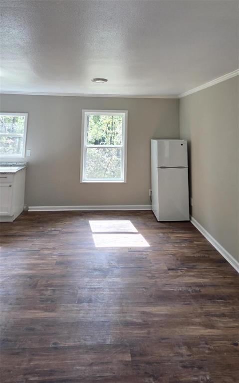333 Canal Street Ringgold, LA 71068 - Photo 7 of 33 an empty room with wooden floor and windows