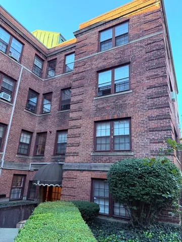 a brick building with a small yard