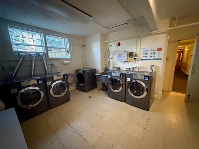 a view of a storage and utility room with washer and dryer
