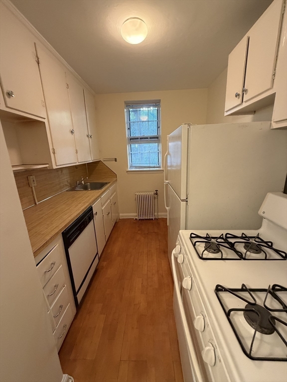 12 Kilsyth Terrace, Unit 11 Boston, MA 02135 - Photo 3 of 12 a kitchen with stainless steel appliances granite countertop a stove a sink and a refrigerator