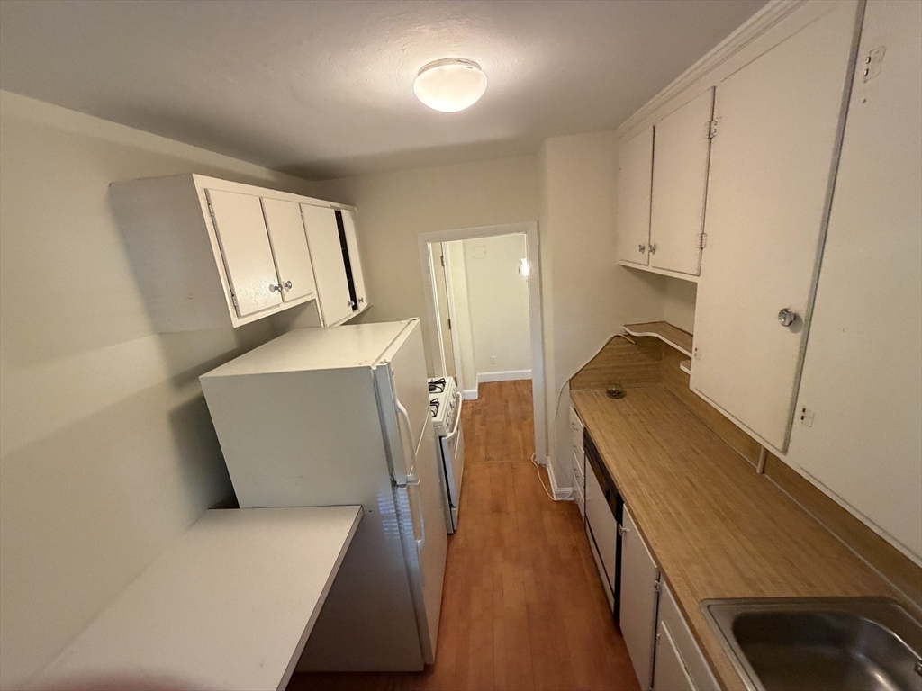 12 Kilsyth Terrace, Unit 11 Boston, MA 02135 - Photo 4 of 12 a living room with furniture and a wooden floor