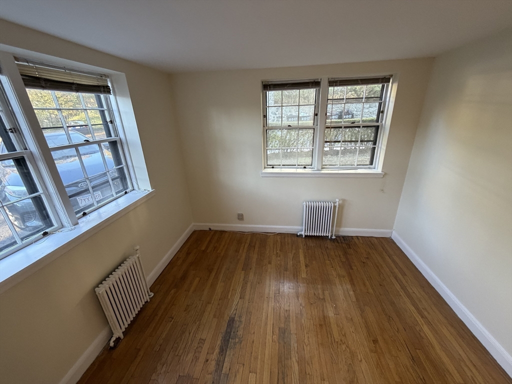 12 Kilsyth Terrace, Unit 11 Boston, MA 02135 - Photo 7 of 12 an empty room with wooden floor and windows