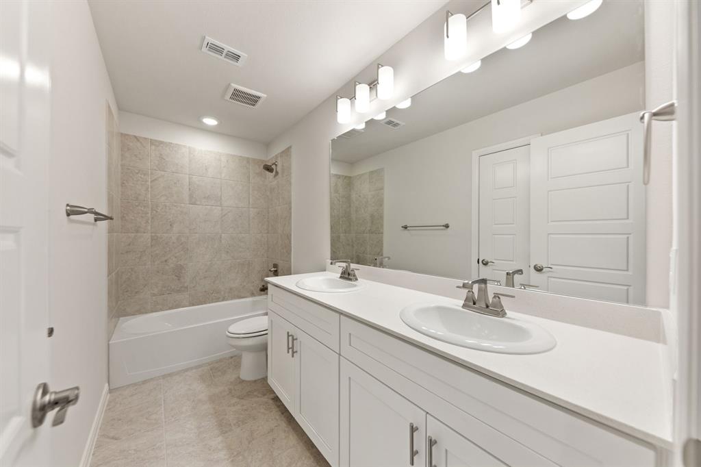 1844 Rosedale Avenue Van Alstyne, TX 75495 - Photo 16 of 26 Guest will enjoy their own vanity space in this thoughtfully designed guest bath.
