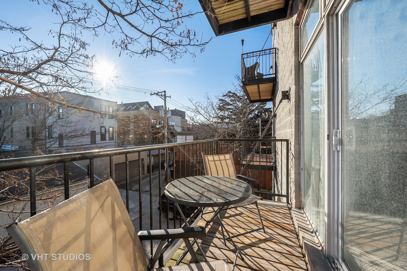 2127 West Rice Street, Unit 2E Chicago, IL 60622 - Photo 14 of 14 a view of a balcony with chair and wooden floor