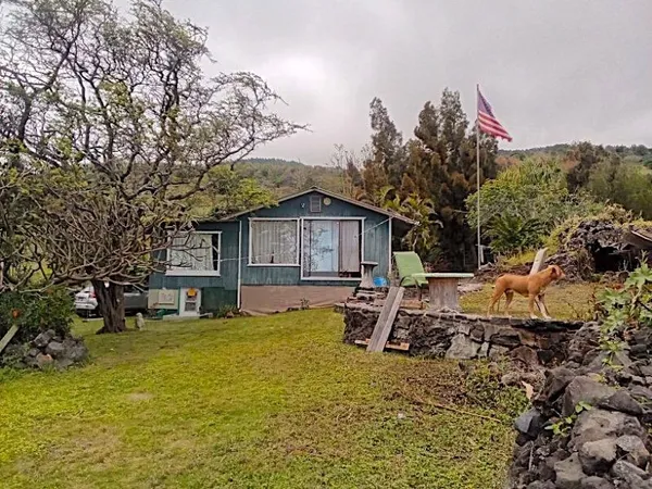 a view of a house with backyard porch and sitting area