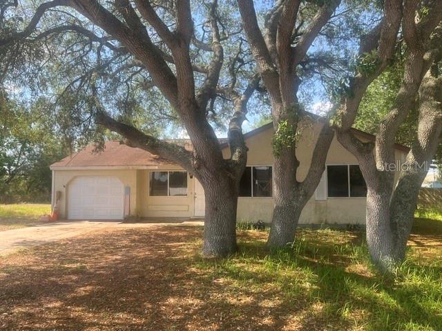 12 Pine Course Way Ocala, FL 34472 - Photo 1 of 29 a view of a yard in front of a house with large tree