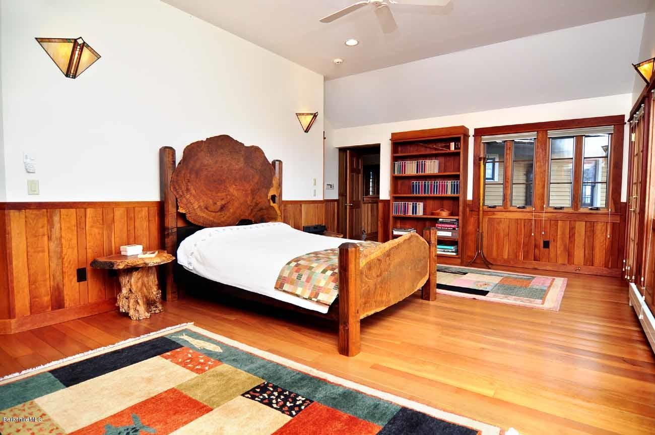 381 Leonhardt Road Becket, MA 01223 - Photo 14 of 47 a bedroom with a bed and wooden floor