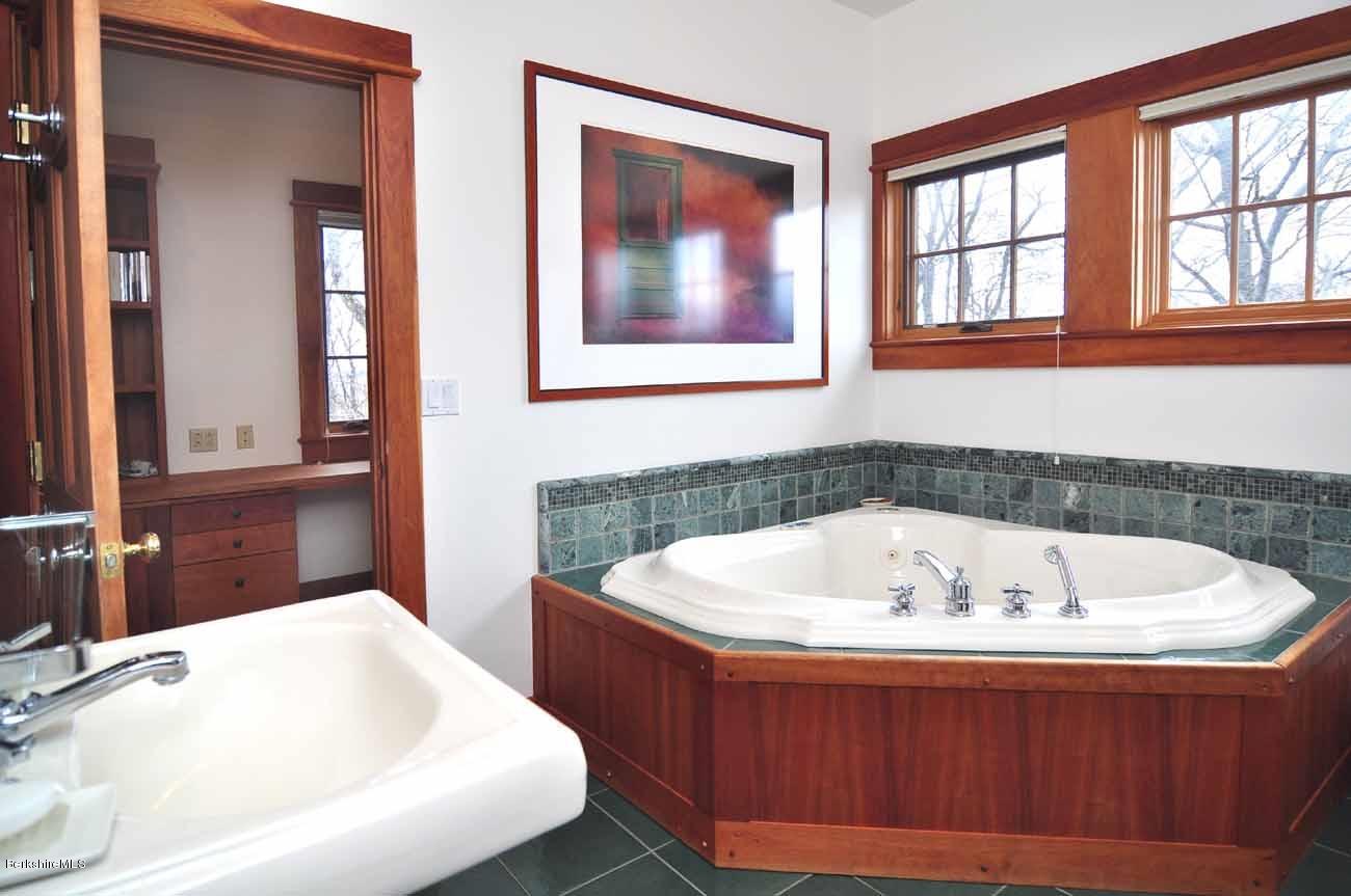381 Leonhardt Road Becket, MA 01223 - Photo 18 of 47 a bath tub sitting in a bathroom next to a window