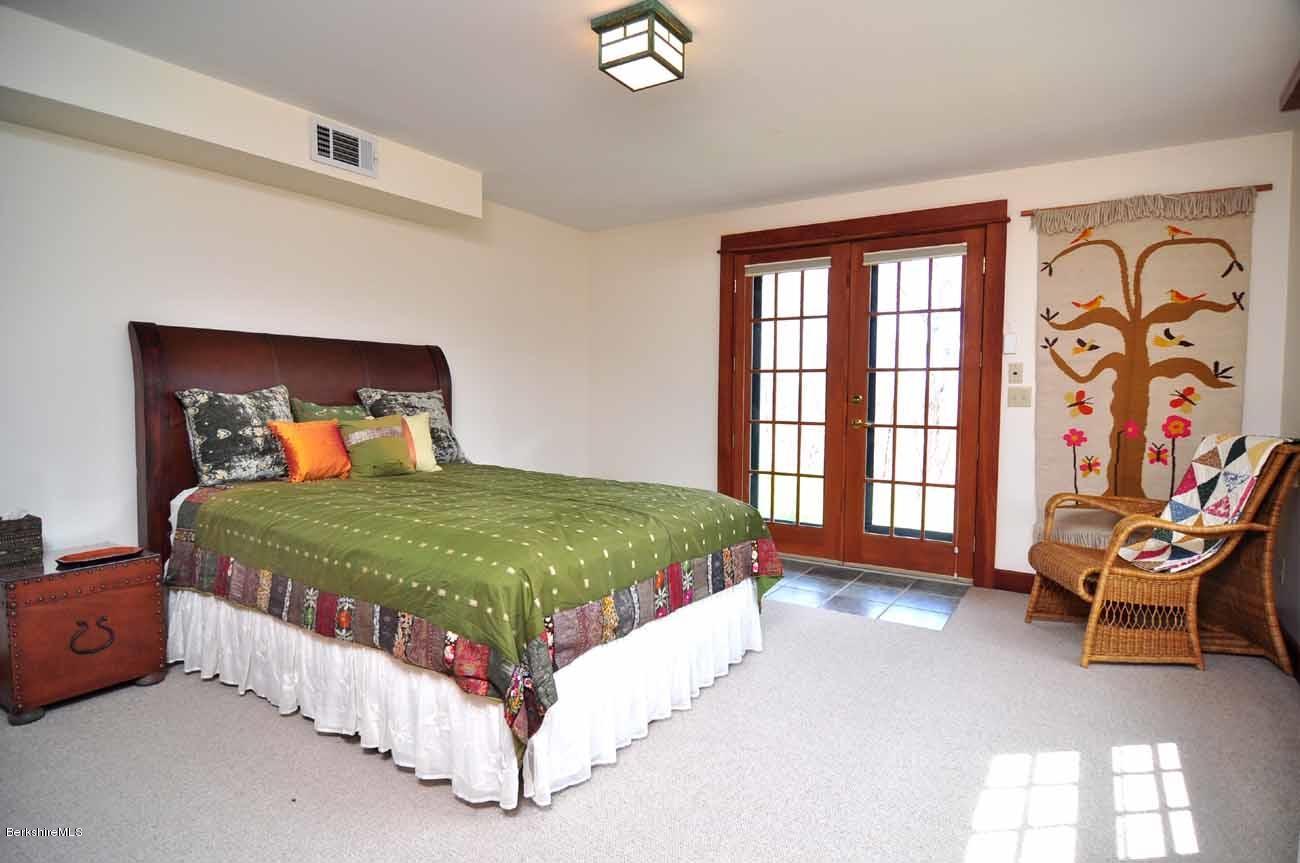 381 Leonhardt Road Becket, MA 01223 - Photo 19 of 47 a bedroom with a bed chair and window
