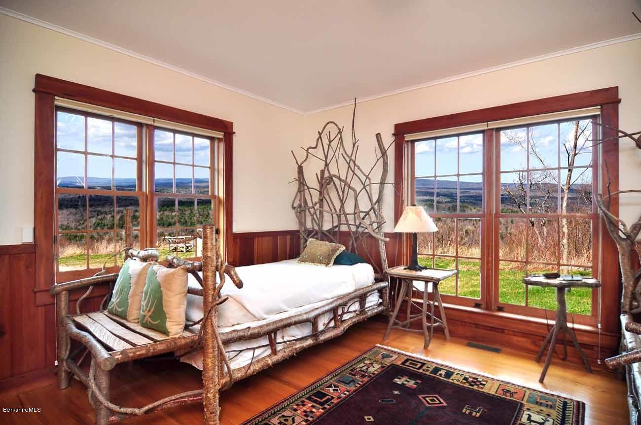 381 Leonhardt Road Becket, MA 01223 - Photo 20 of 47 a bedroom with furniture and large windows