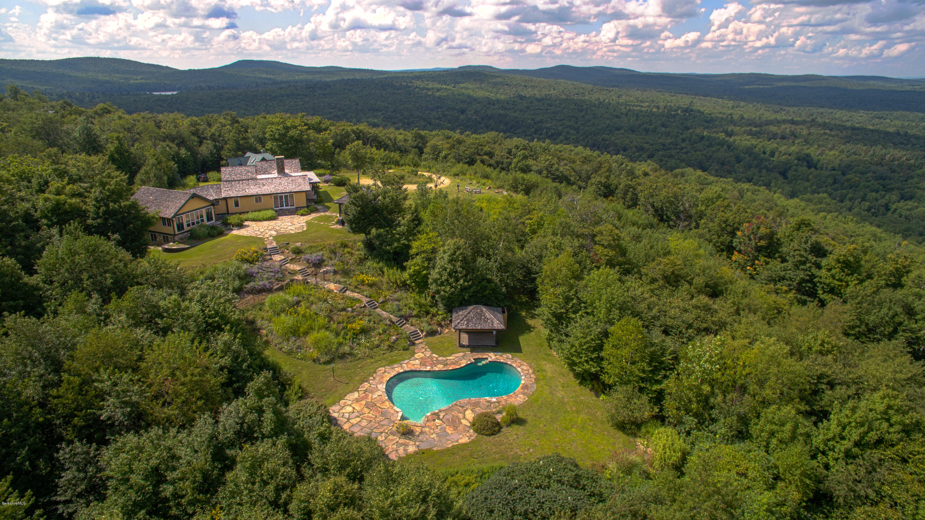 381 Leonhardt Road Becket, MA 01223 - Photo 3 of 47 a view of a lake with a mountain in the background