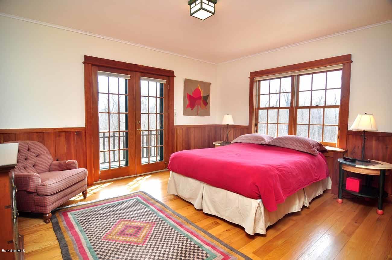 381 Leonhardt Road Becket, MA 01223 - Photo 21 of 47 a bed room with a bed and a chair