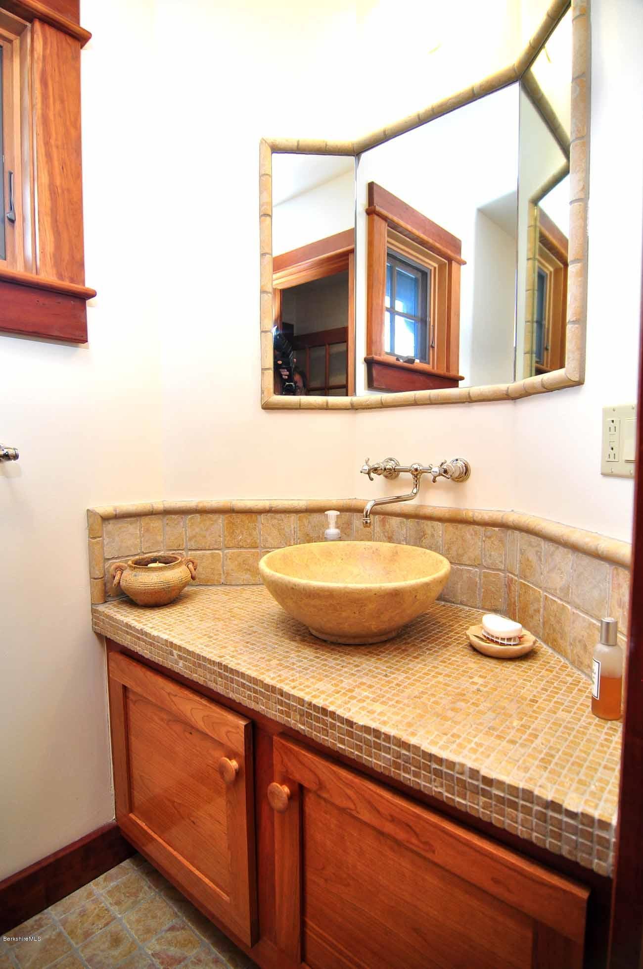 381 Leonhardt Road Becket, MA 01223 - Photo 22 of 47 a bathroom with a granite countertop sink and a mirror