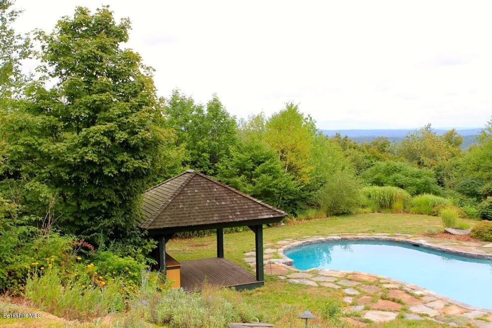 381 Leonhardt Road Becket, MA 01223 - Photo 35 of 47 a view of a swimming pool with an outdoor space and seating area