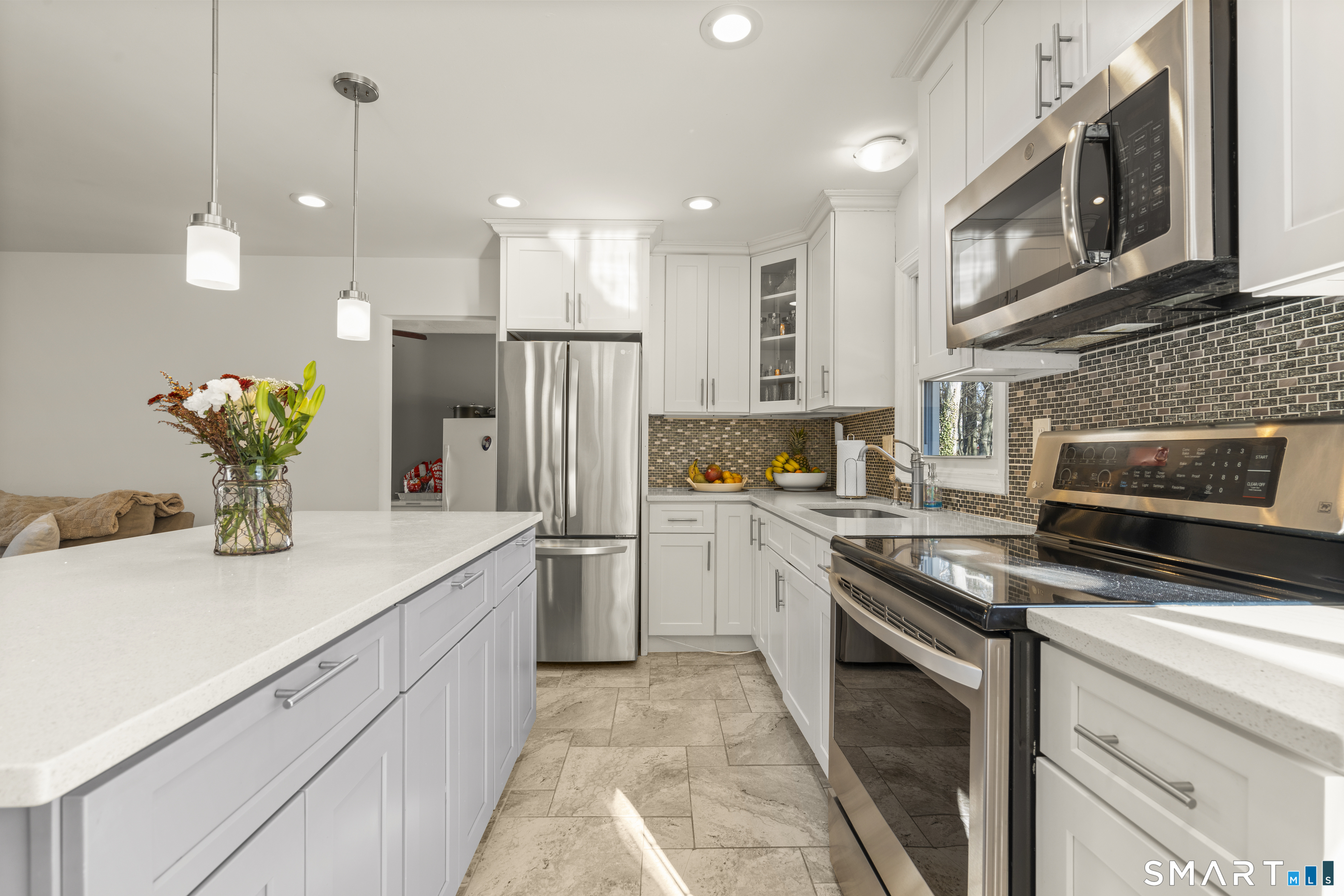 342 West Spring Street West Haven, CT 06516 - Photo 11 of 30 a kitchen with a sink a refrigerator and a stove top oven