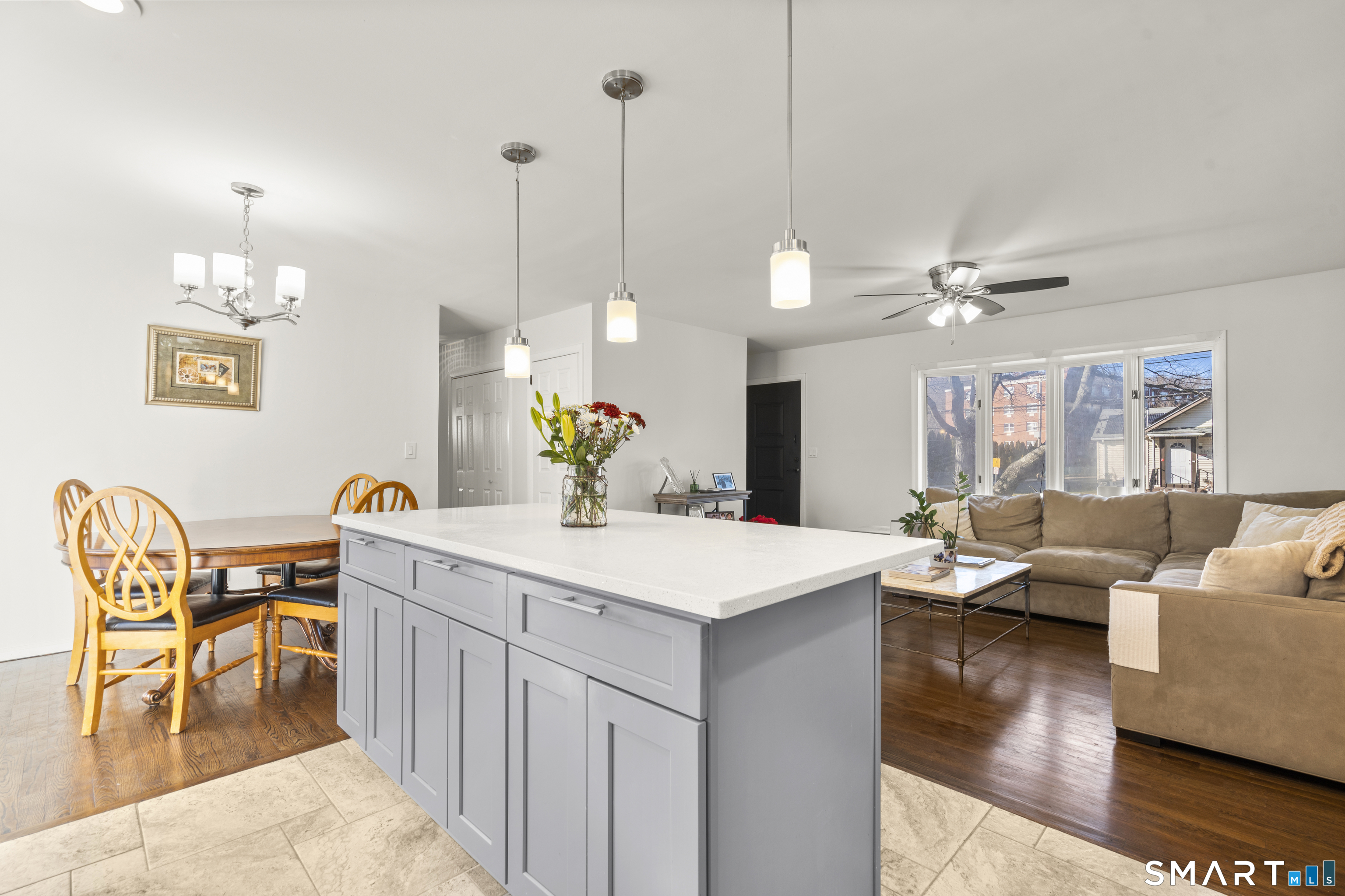 342 West Spring Street West Haven, CT 06516 - Photo 12 of 30 a view of a dining room and livingroom with furniture wooden floor a chandelier