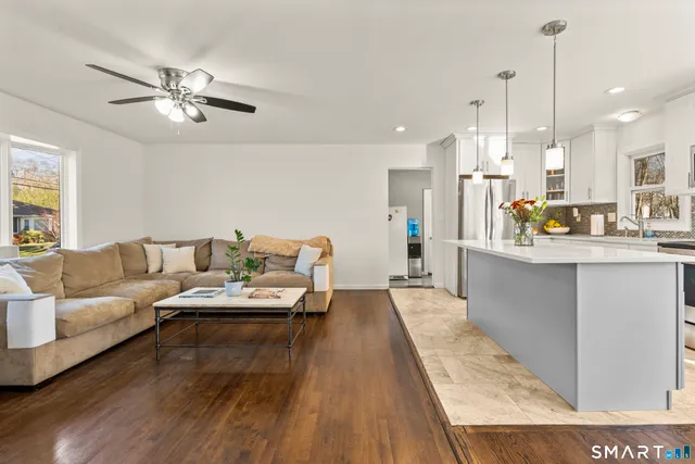 a living room with furniture and kitchen view