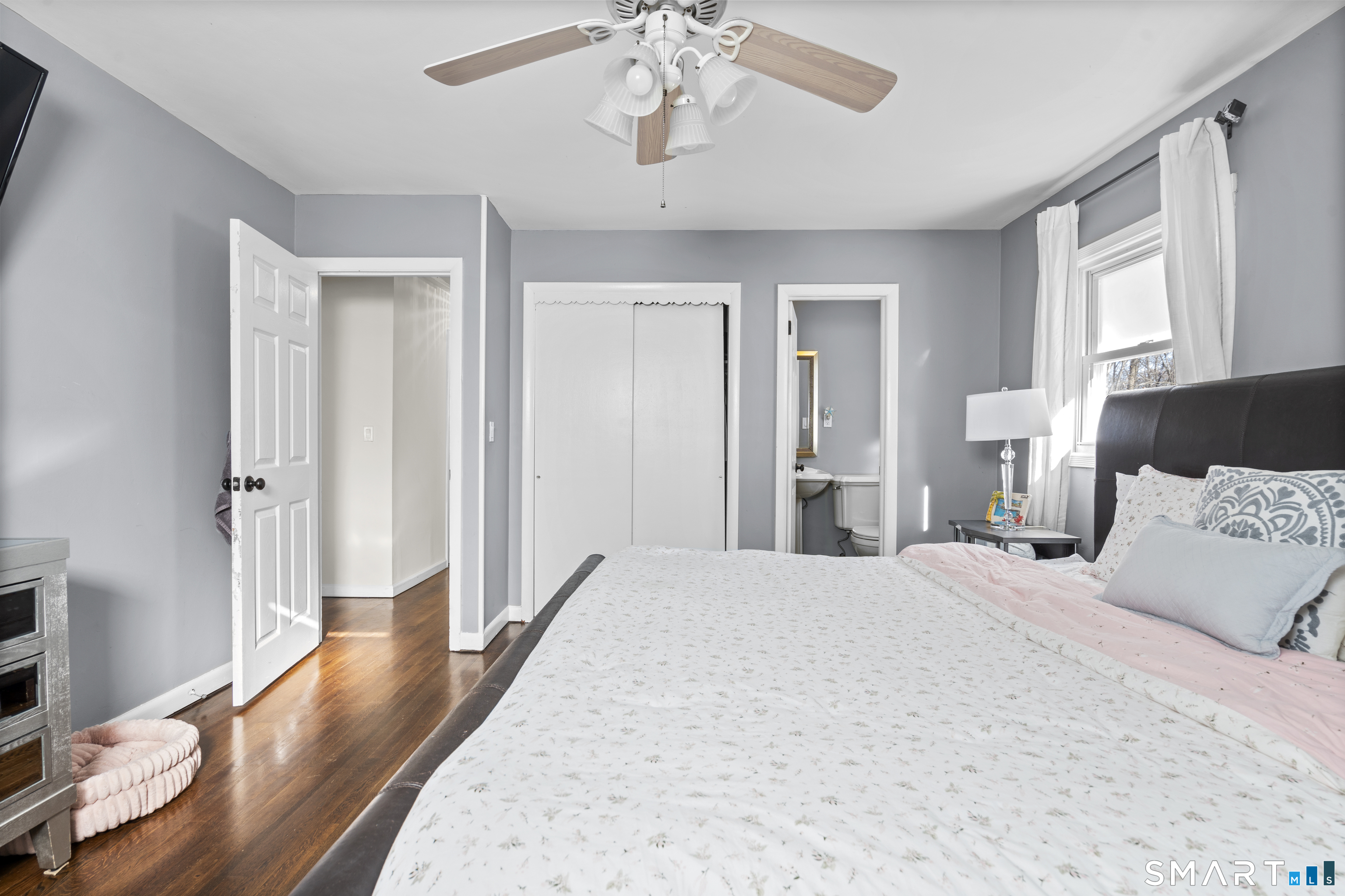 342 West Spring Street West Haven, CT 06516 - Photo 18 of 30 a spacious bedroom with a bed and a chandelier