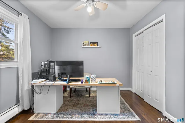 a room with a table chairs and a window